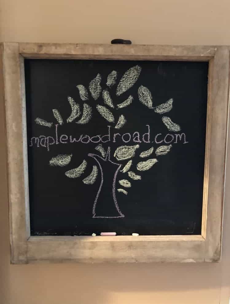 Rustic chalkboard with drawing of our logo.