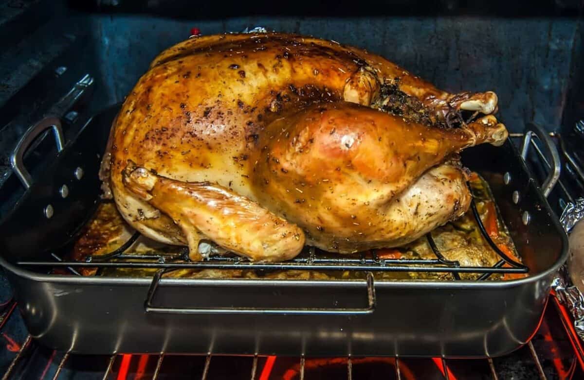 Turkey in roasting pan in the oven.