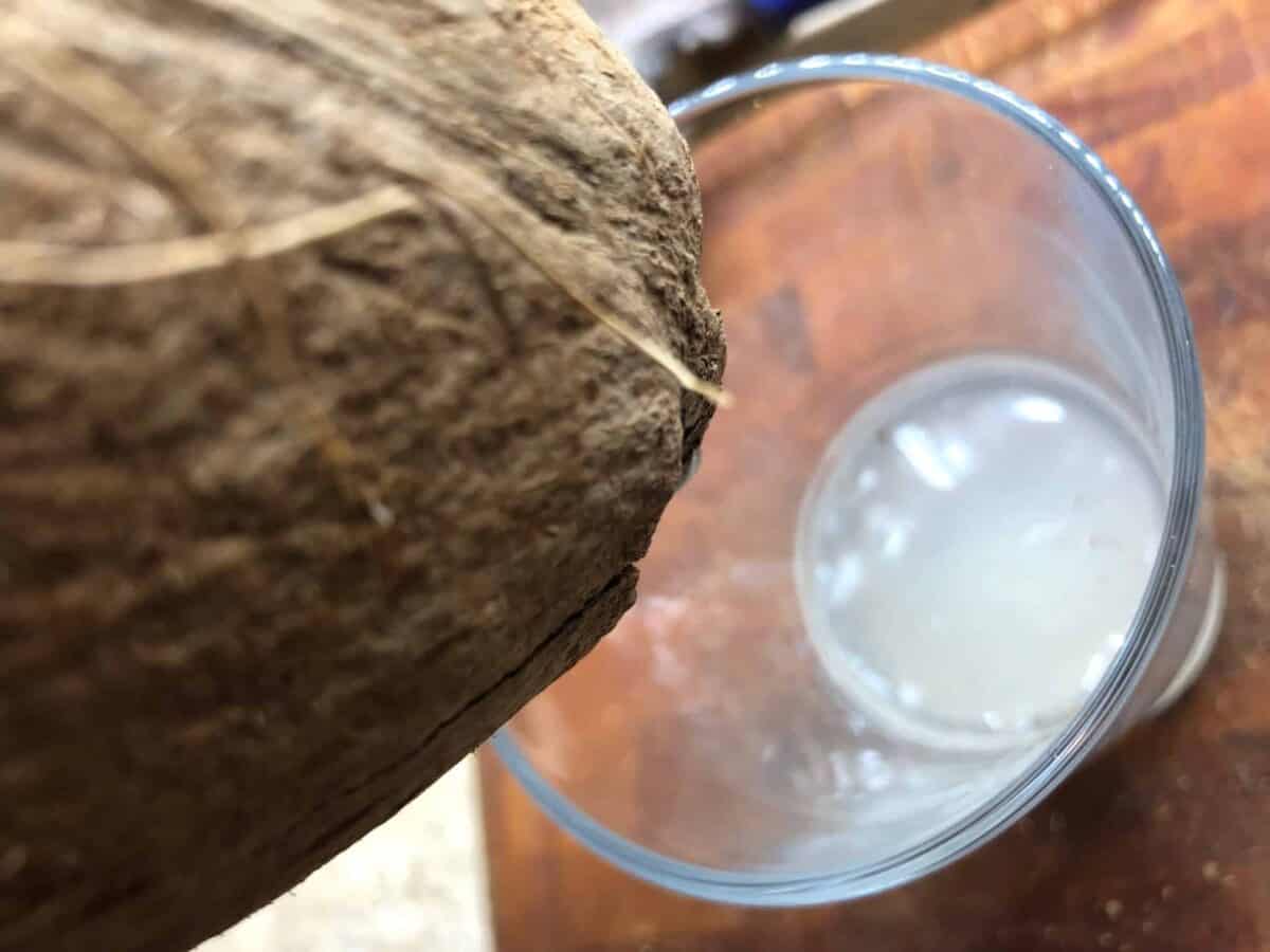 Pouring the coconut milk out.