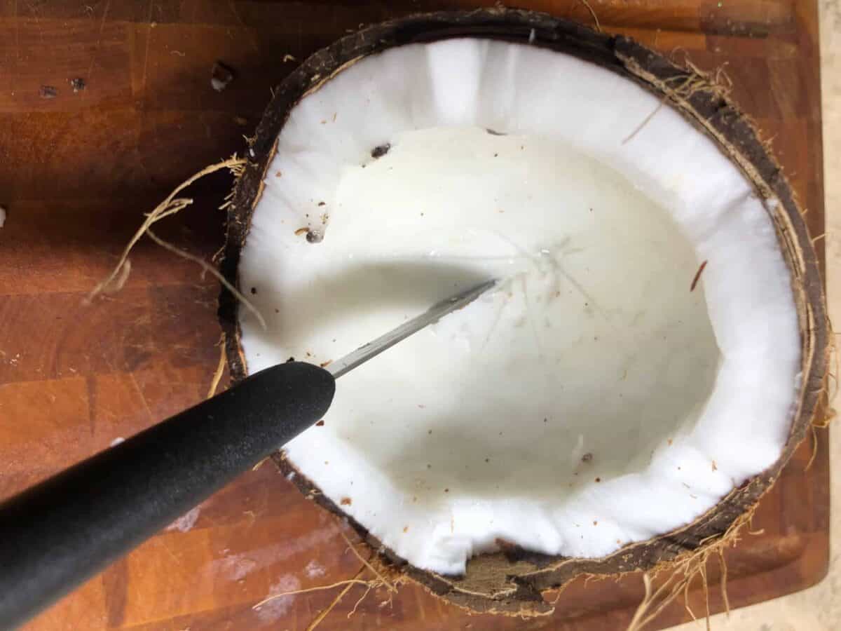 Scoring the coconut meat.
