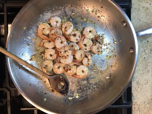 Cooking shrimp with garlic and hot pepper flakes.