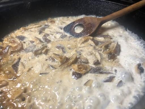 Reducing the sauce before adding the chives.