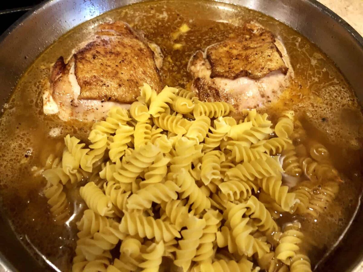 Cooking pasta with the chicken.