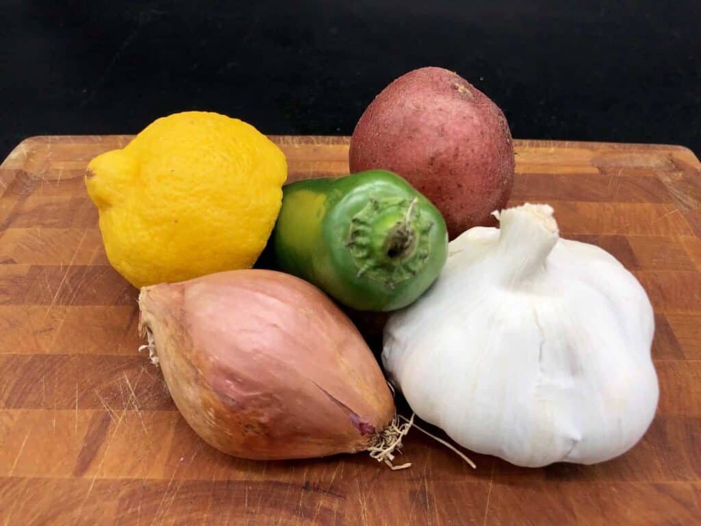 Essential Food Pantry - Garlic, shallots, potato, lemon, and jalapeño (Photo by Erich Boenzli)