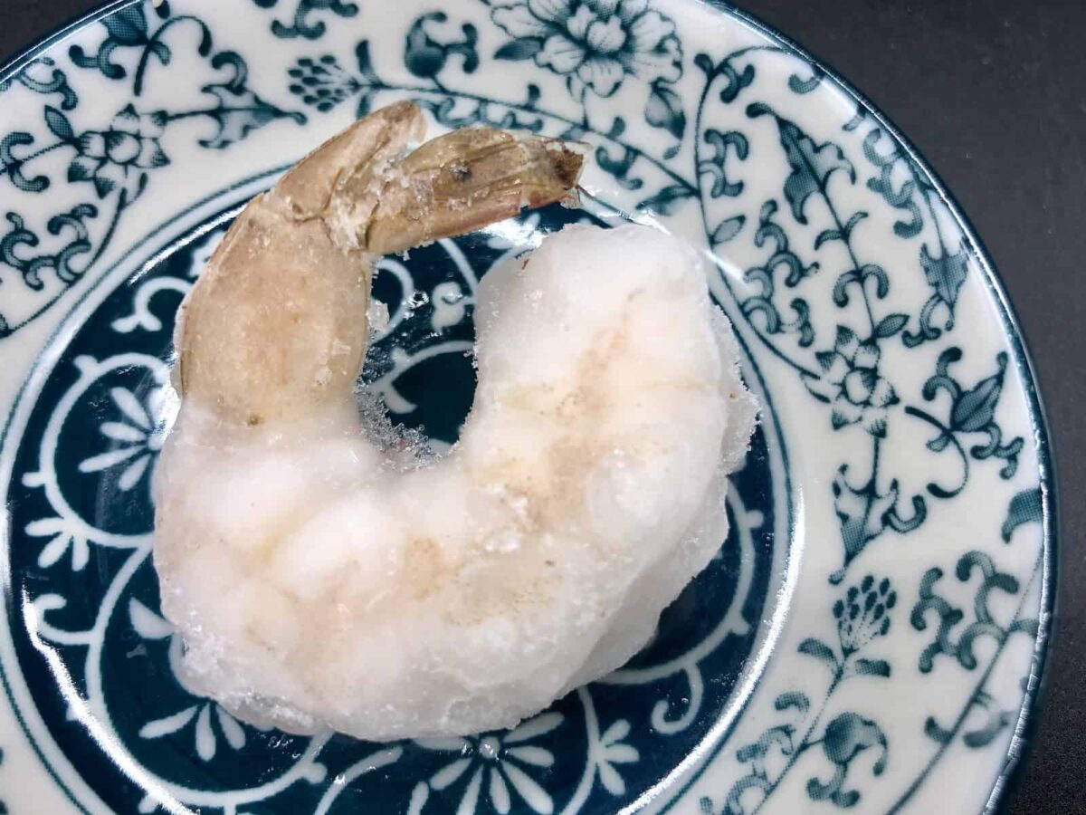 Frozen, raw, peeled, deveined, tail-on shrimp.