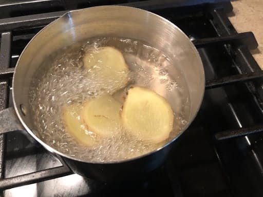 Simmering ginger in a pot.