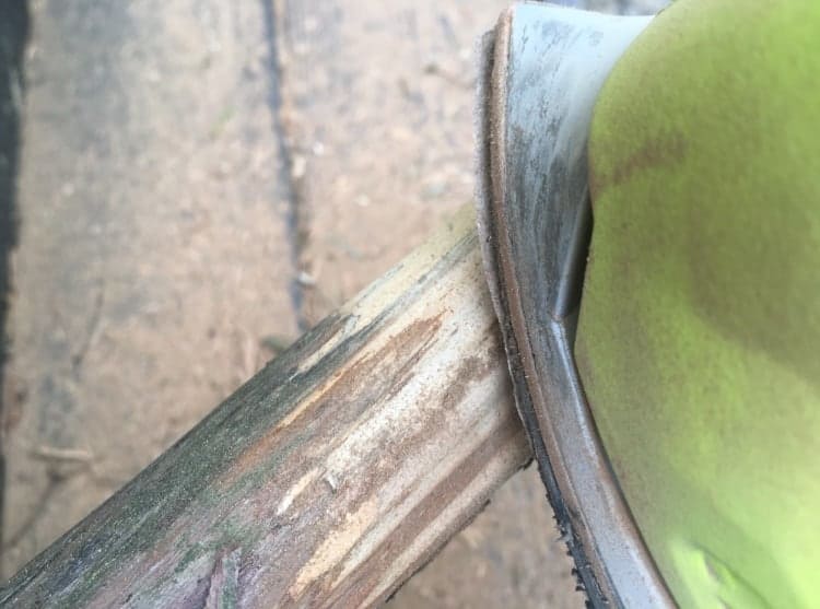 Using an electric sander to smooth out the branches.