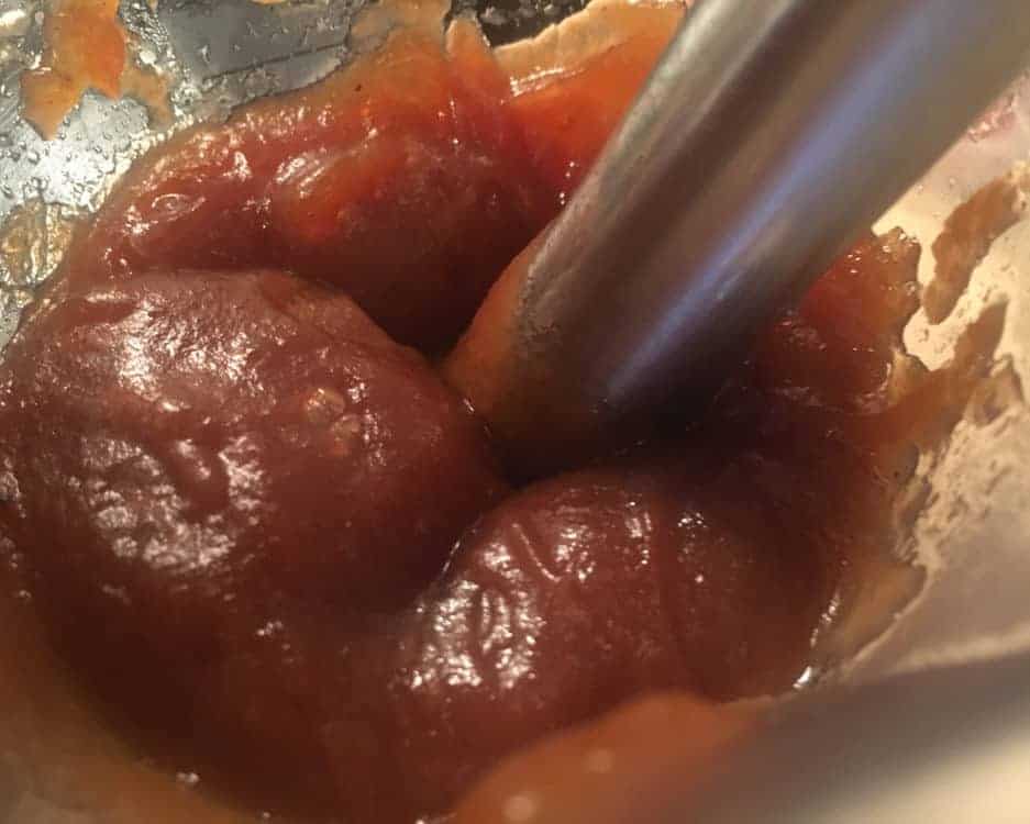 Smoothing apple butter with immersion blender.