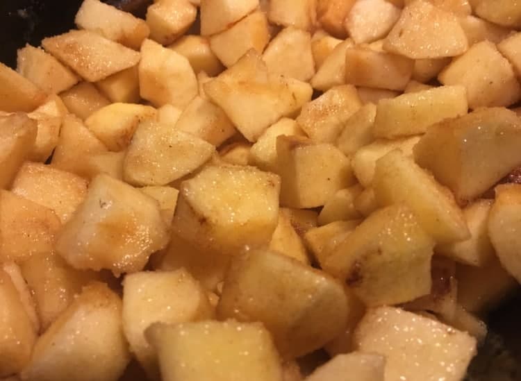 Apples tossed with other ingredients, ready for cooking.