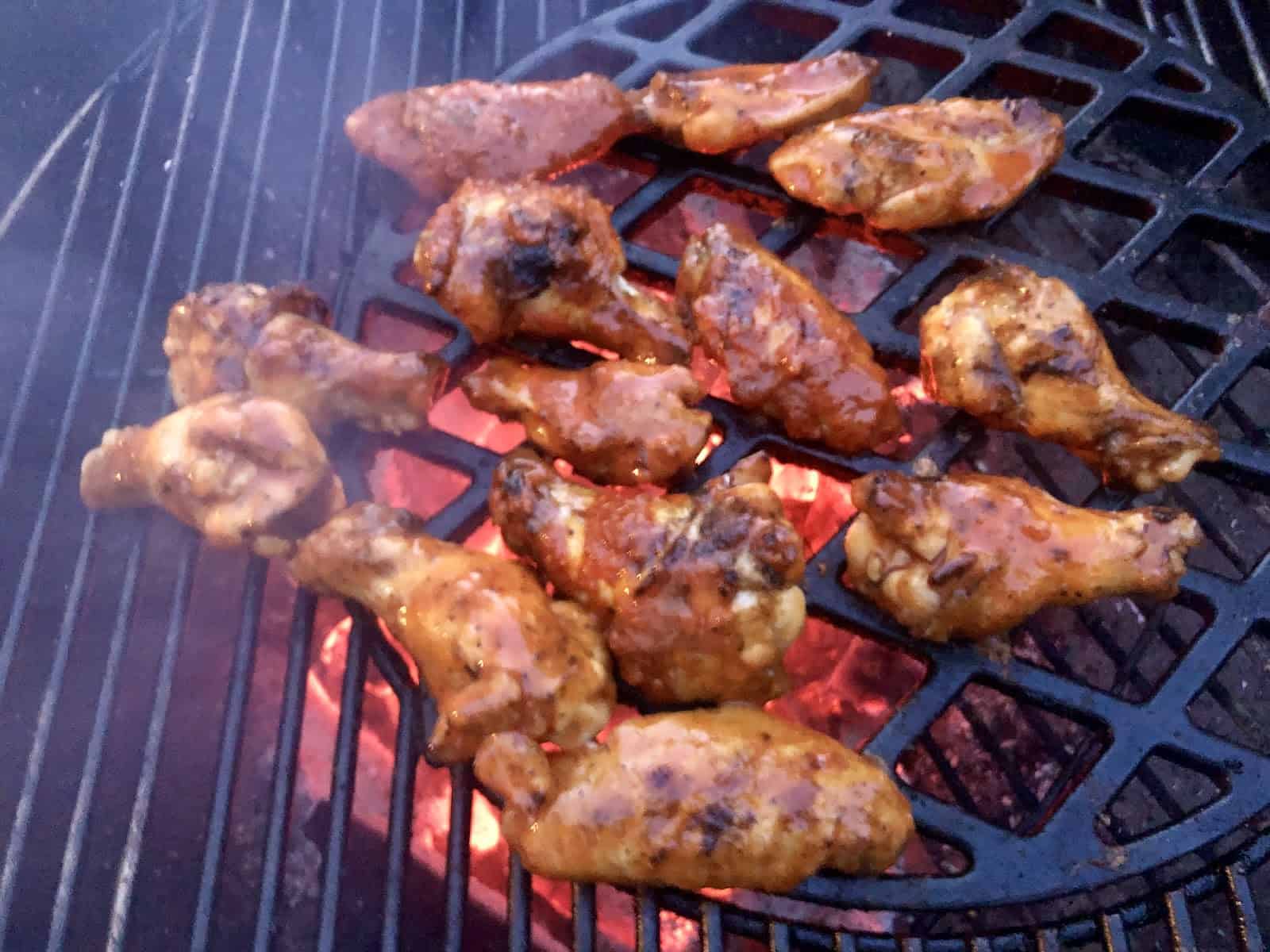 Hot sauce coated wings on grill.