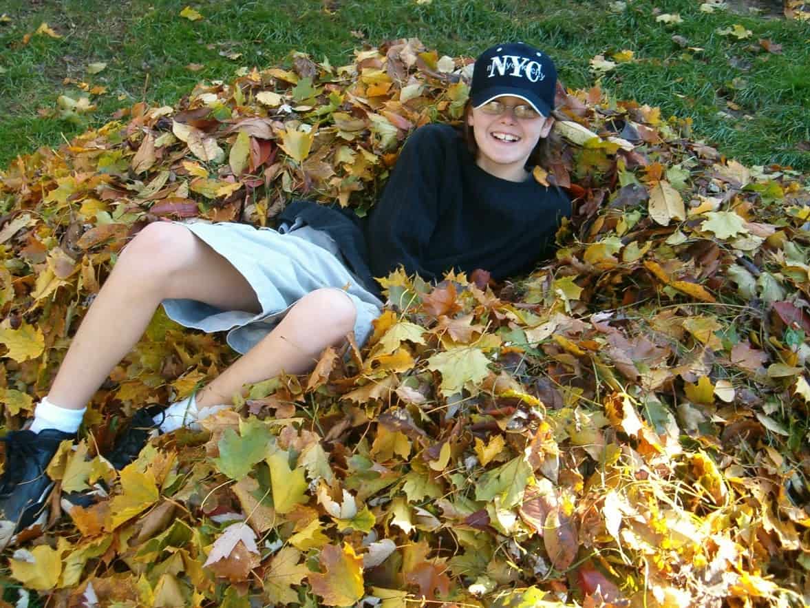 My son playing in a leaf pile.