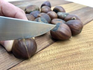 Chestnuts Roasting on an Open Fire - With a sharp knife, cut a cross on the round side (Photo by Erich Boenzli)