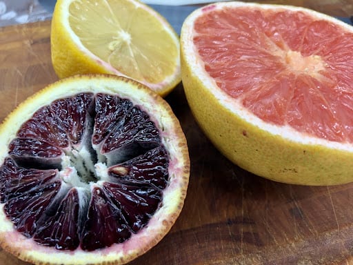 Sliced in half - lemon, pink grapefruit, and blood orange.