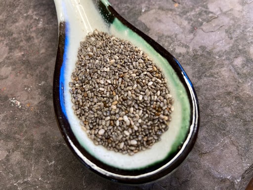 Raw chia seeds in a spoon.