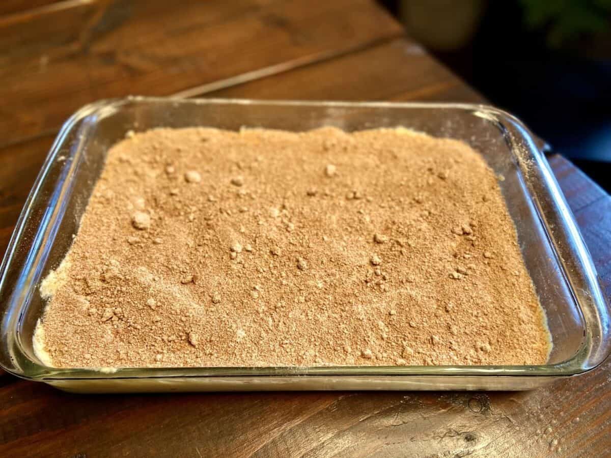 Sugar, cinnamon, and cocoa layer over the first layer of cake batter.