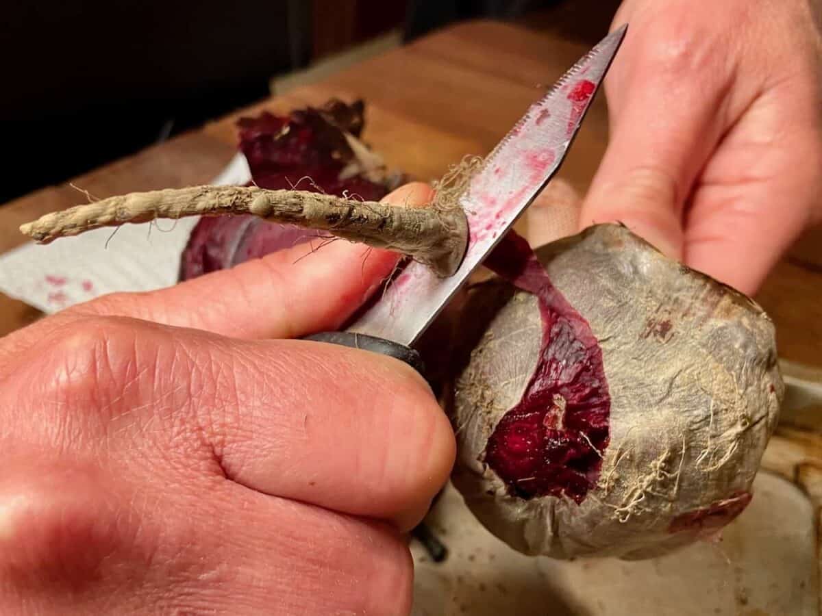 Peeling a beet with a knife.