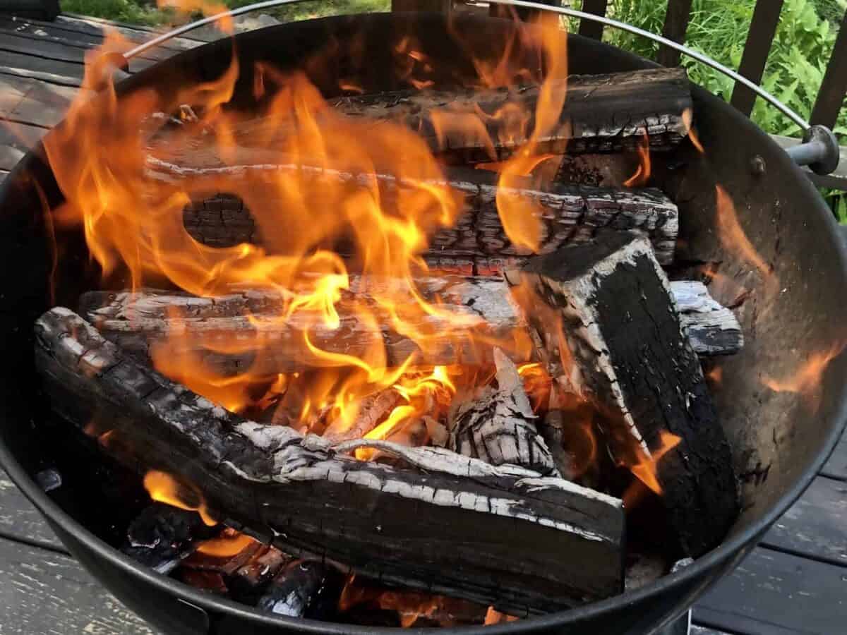 Starting a fire in the grill.