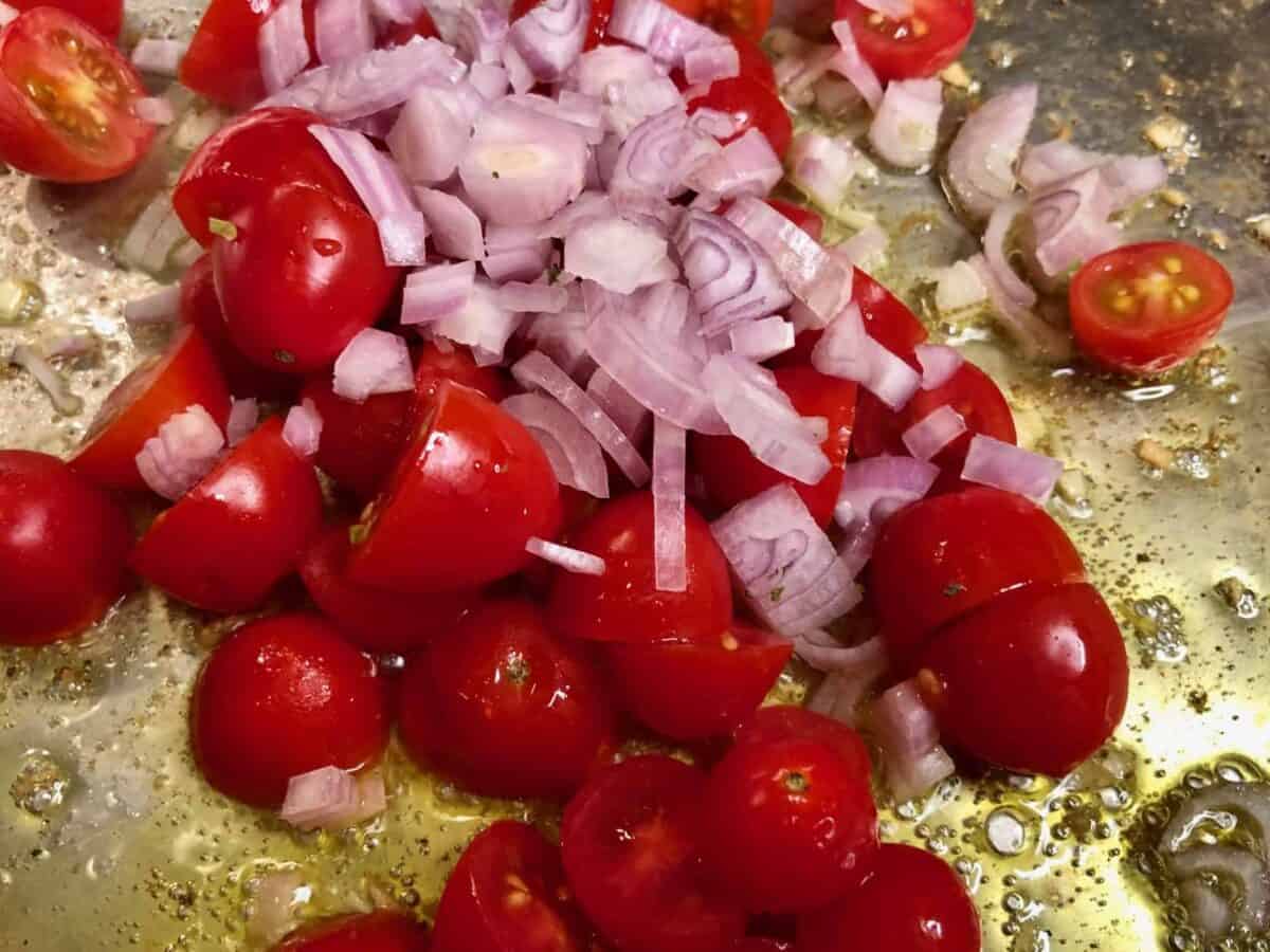 Remove shrimp and garlic, add tomatoes and shallots.