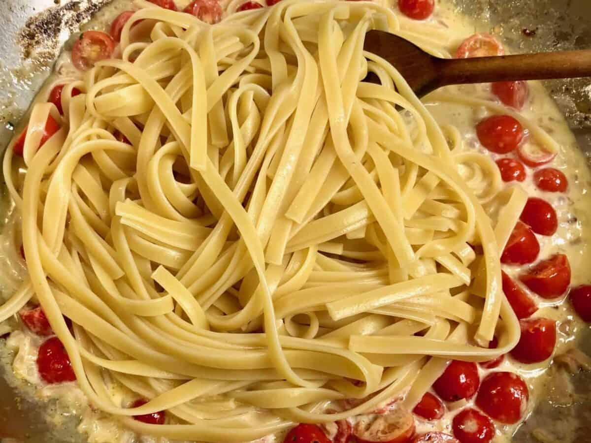 Stirring in the pasta.