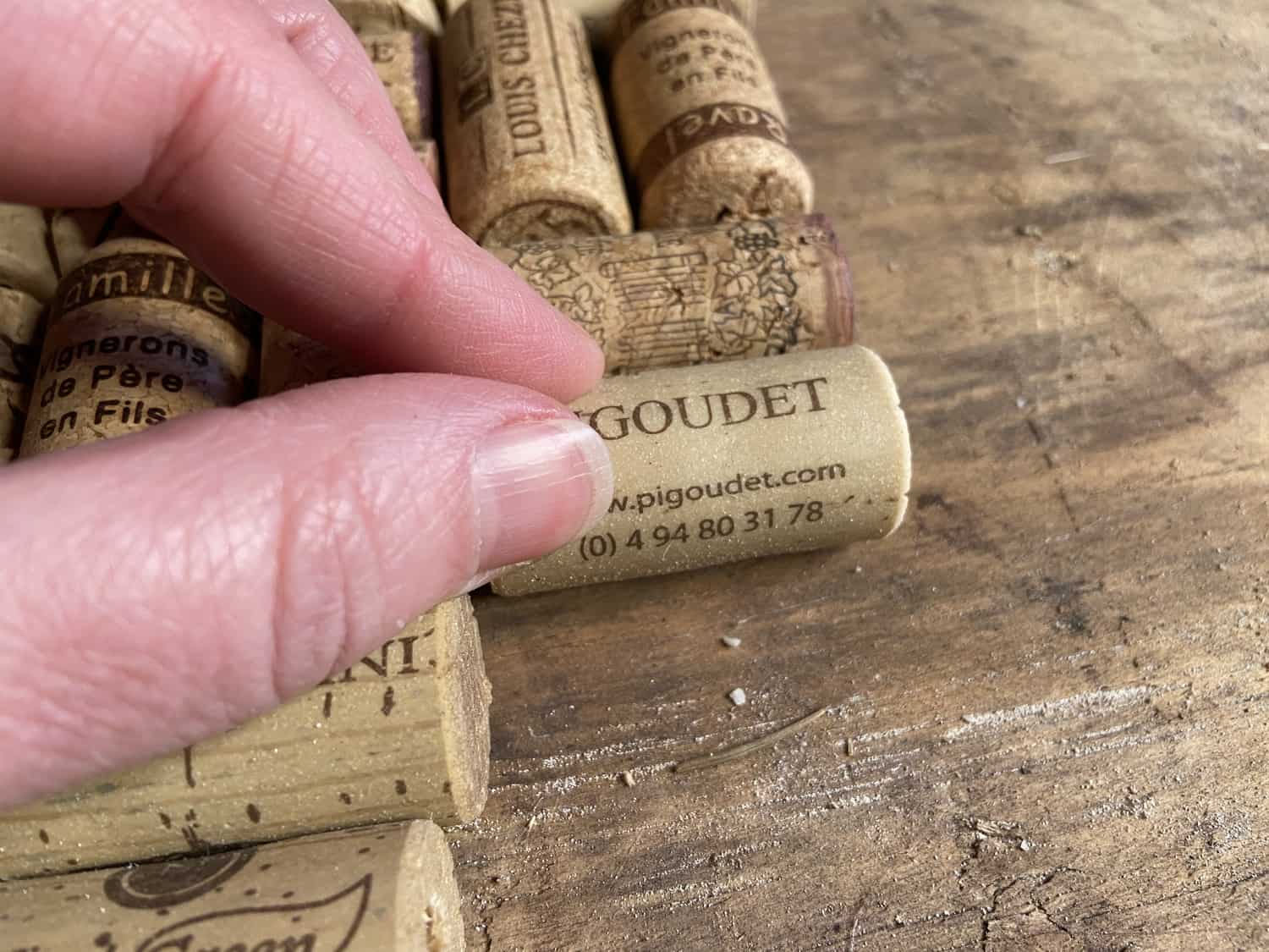 Gluing corks to a piece of wood.
