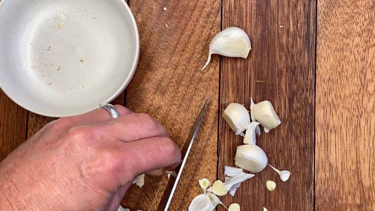 Chopping garlic cloves.
