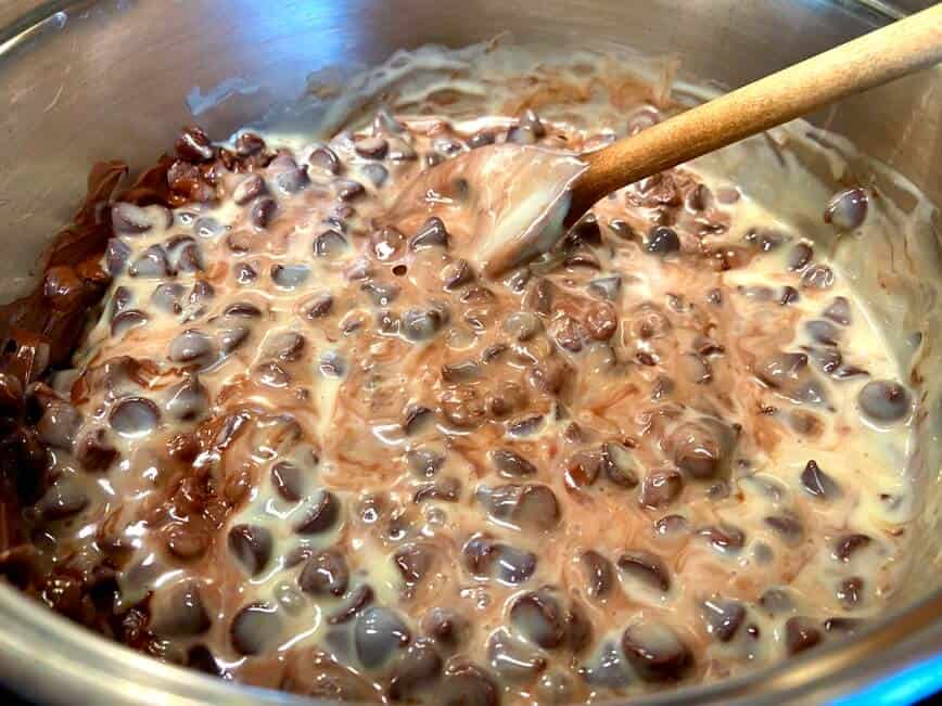 Mixing the fudge in a pot with a wooden spoon.