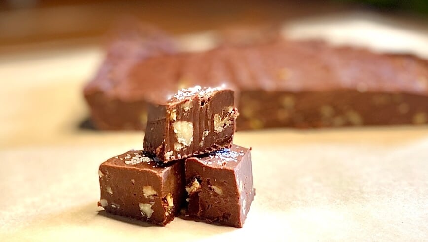 Three pieces of fudge stacked on a table.