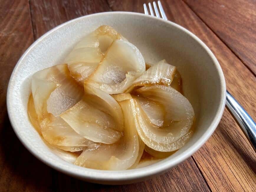 Sliced onion, served in a small bowl.