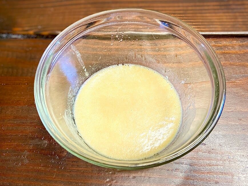 Mixing lemon, olive oil, mustard, Worcestershire, and mayonnaise in a bowl.