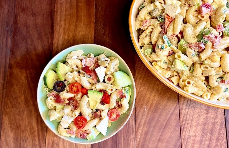 Small and large bowls of macaroni salad.