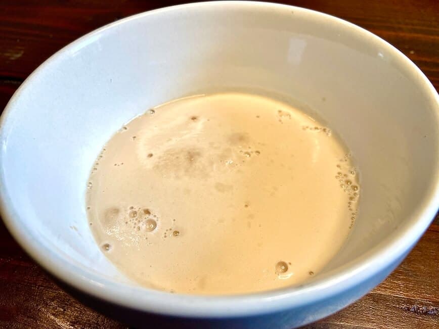 Water, sugar, and yeast in bowl.
