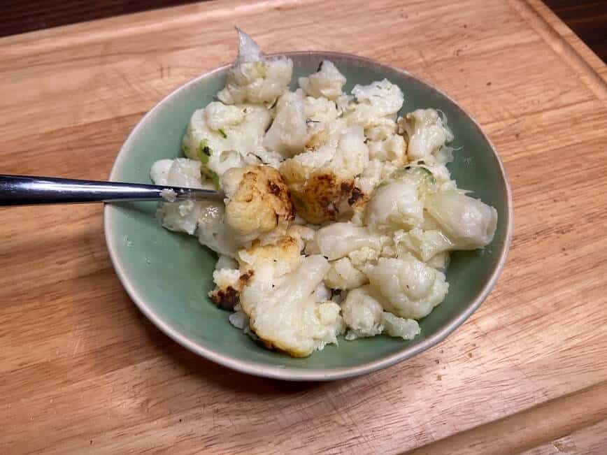 Oven roasted cauliflower in a dish.