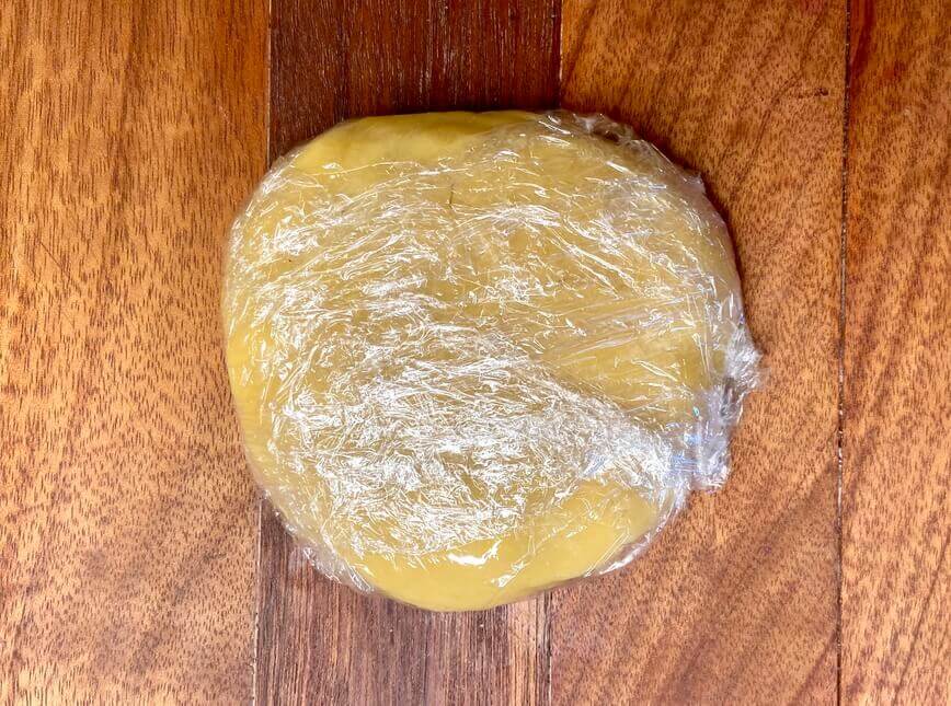 Pastry crust wrapped in plastic wrap.