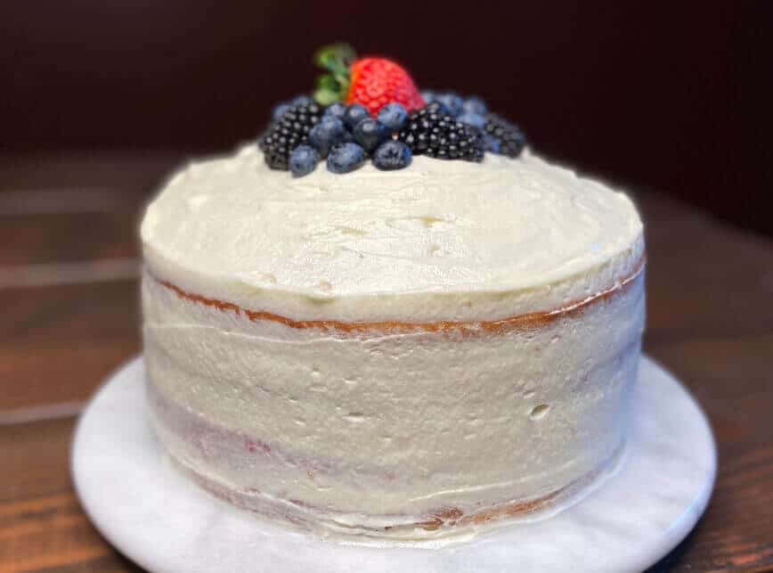 Cake decorated with berries on top.