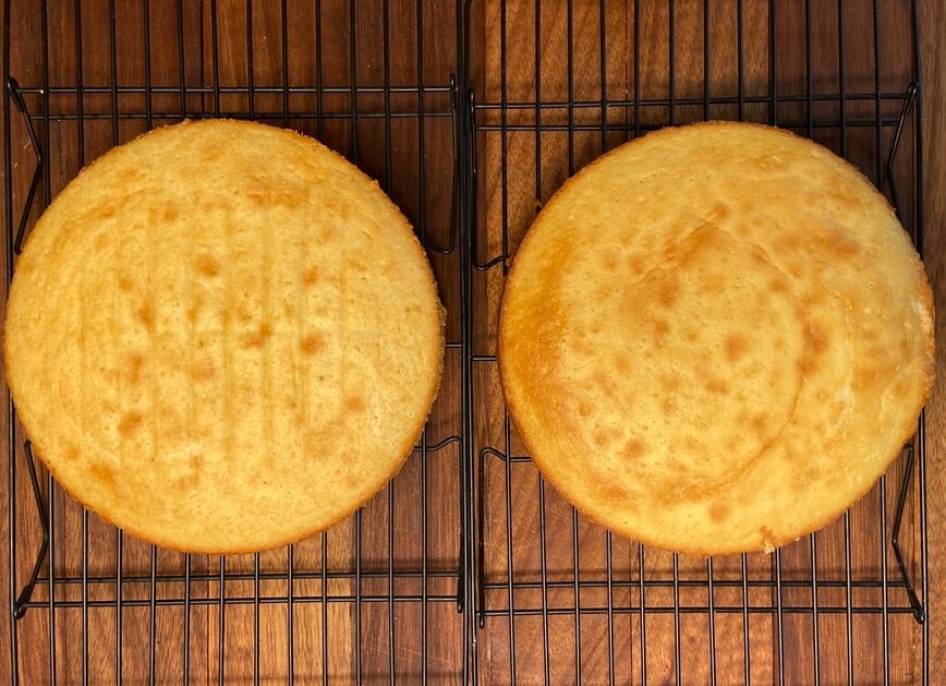 Two baked cakes on cooling racks.