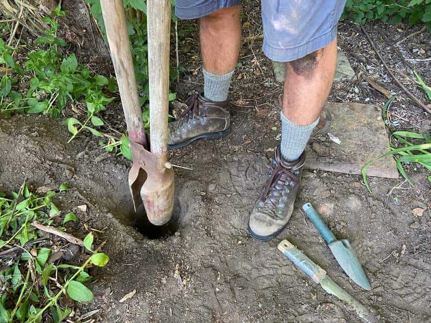 Using a post digger to dig holes.