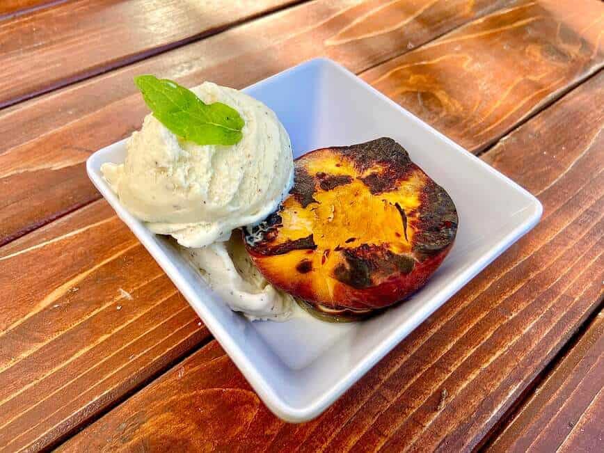 Grilled peach with vanilla ice cream.