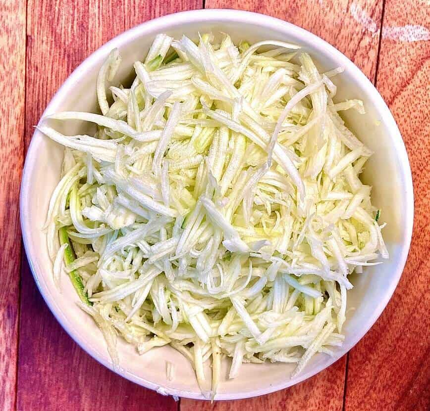 Shredded zucchini in a bowl.