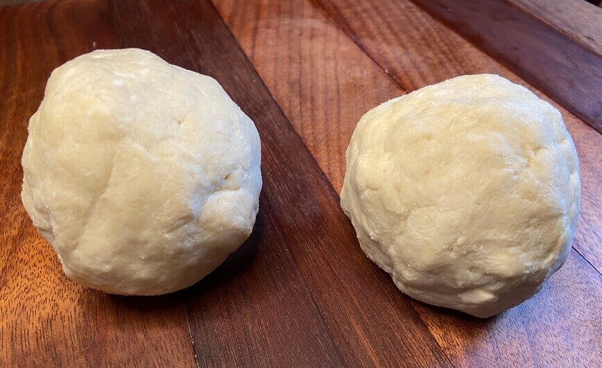 Dough divided in two and shaped into round balls.