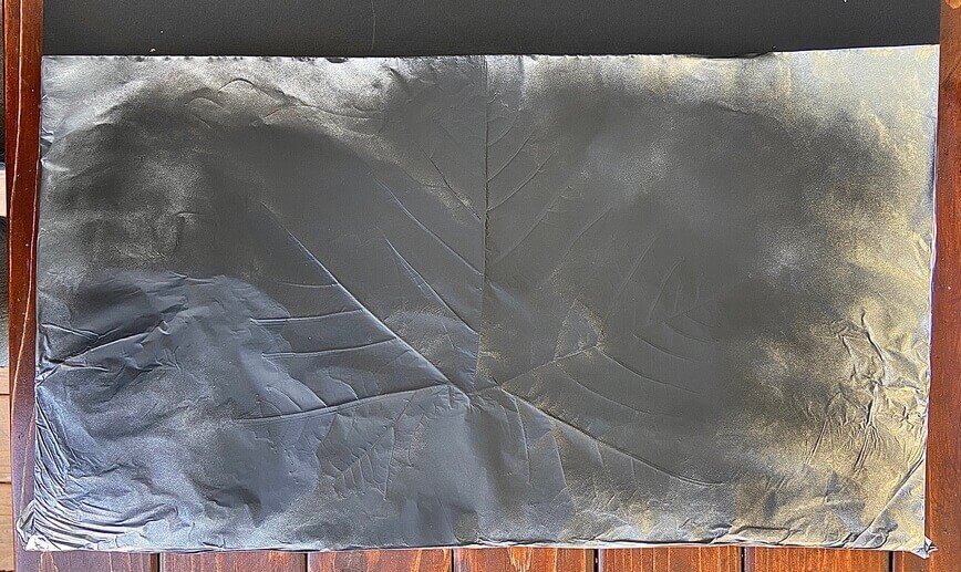 Foil sprayed with black spray paint.