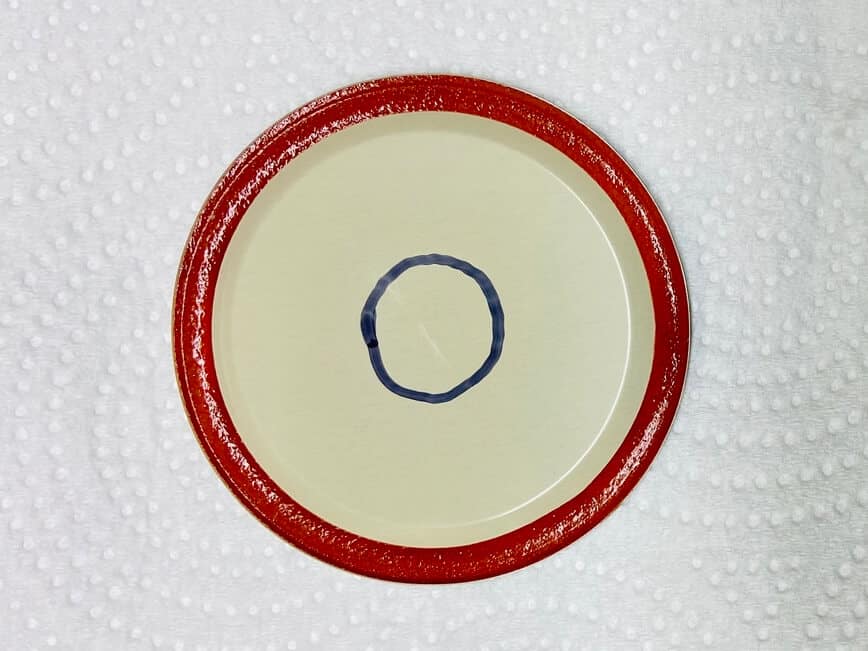 Circle drawn with a marker on the underside of the flat lid.