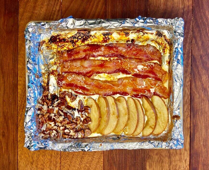 Baked bacon, apple slices, and walnuts.