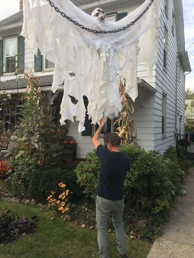 Big Guy Halloween decoration - My strong guy getting the Big Guy in place for Halloween (Photo by Viana Boenzli)