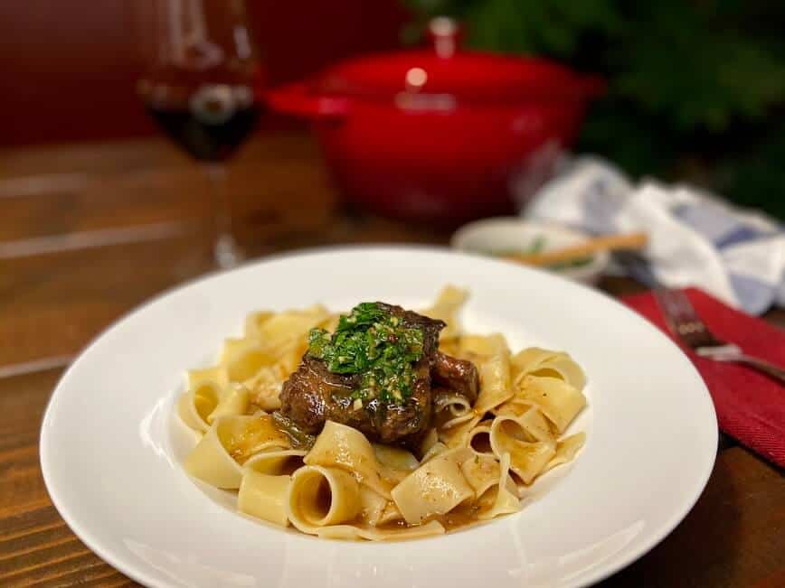 Ribs served with gremolata on top, over pasta.