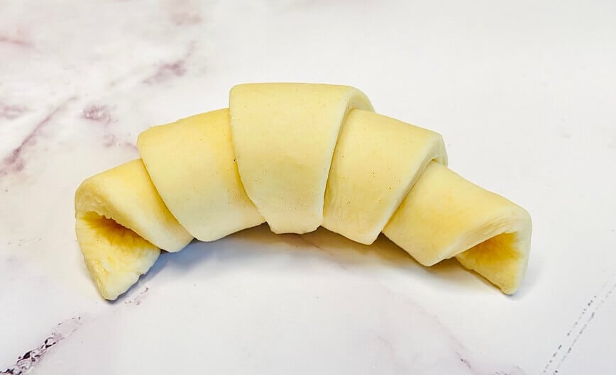Formed croissant, before baking.