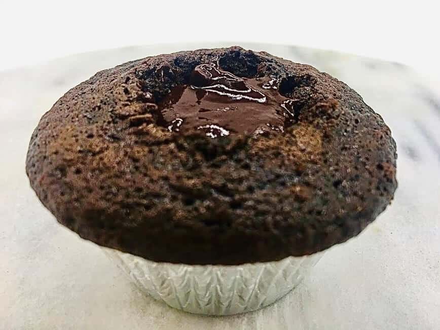 Filling center of cupcake with chocolate ganache.