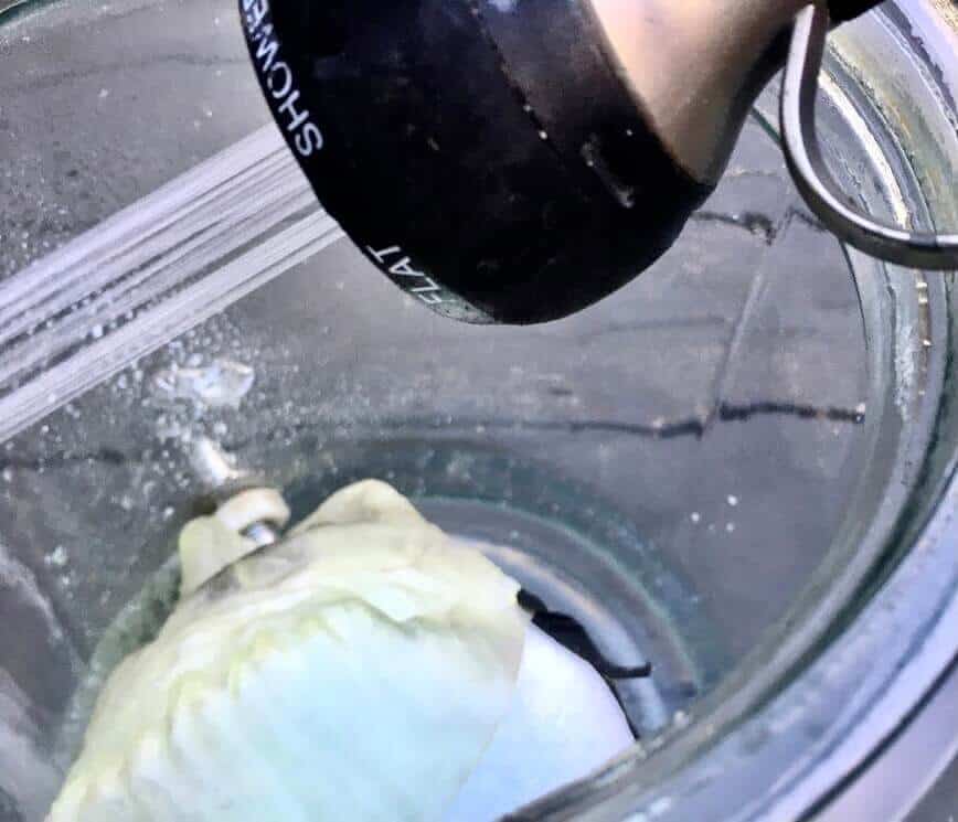 Mask in jar, filling the jar with water.