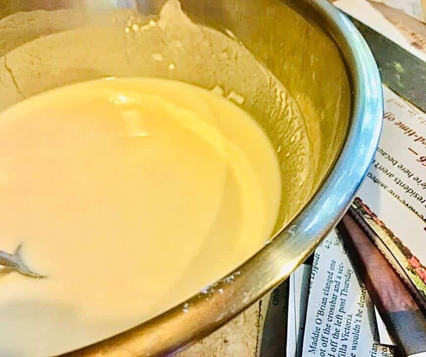 Mixing the paper mache paste in a bowl.