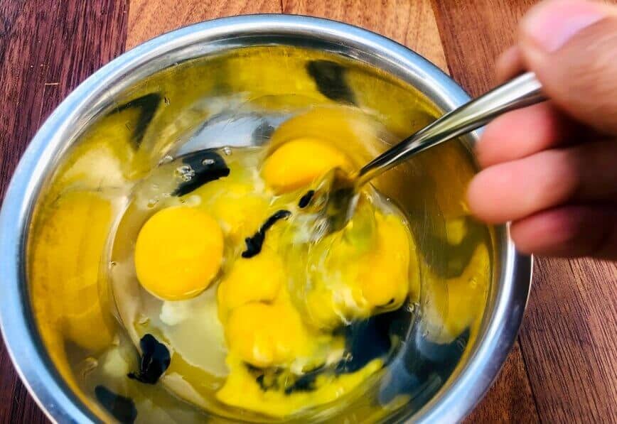 Whisking eggs with squid ink.