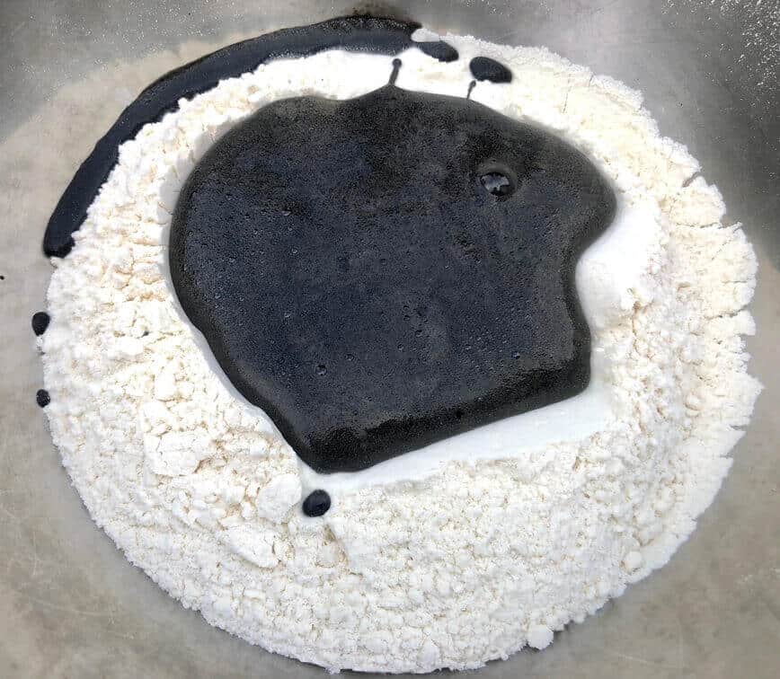 Mixing flour with squid ink.